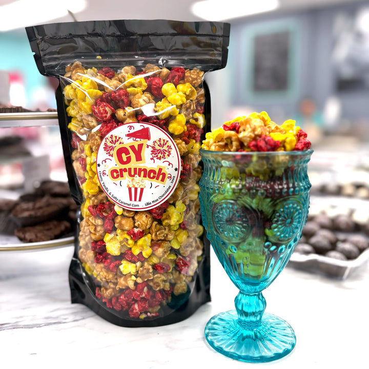 Our Cy Crunch Popcorn features our sweet and salty salted caramel corn, creamy vanilla popcorn, and a burst of tangy red cherry popcorn.