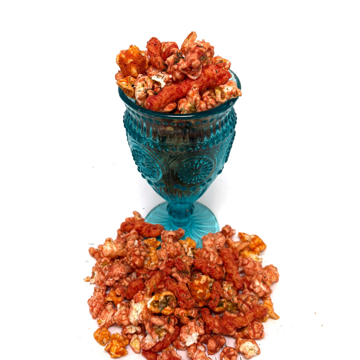 Our Eat My Dust Dill Popcorn starts with a blend of White Cheddar and Better Cheddar popcorn, then we turn up the heat with the punchy, tangy kick of dill Hot Cheetos flavor. Finished off with a dusting of Dill Hot Cheetos and sprinkled with whole Dill Hot Cheetos for that extra flavor kick!
