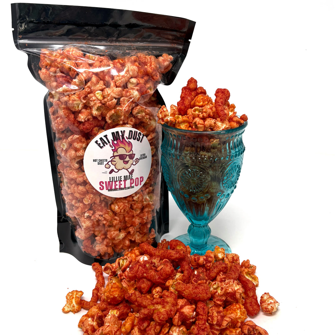  Our Eat My Dust Popcorn is a crave-worthy mix of White Cheddar and Better Cheddar popcorn that is coated in a light layer of fiery Hot Cheetos dust for a bold, cheesy heat that hits just right. Topped off with Hot Cheeto Dust and whole Hot Cheetos sprinkled throughout.