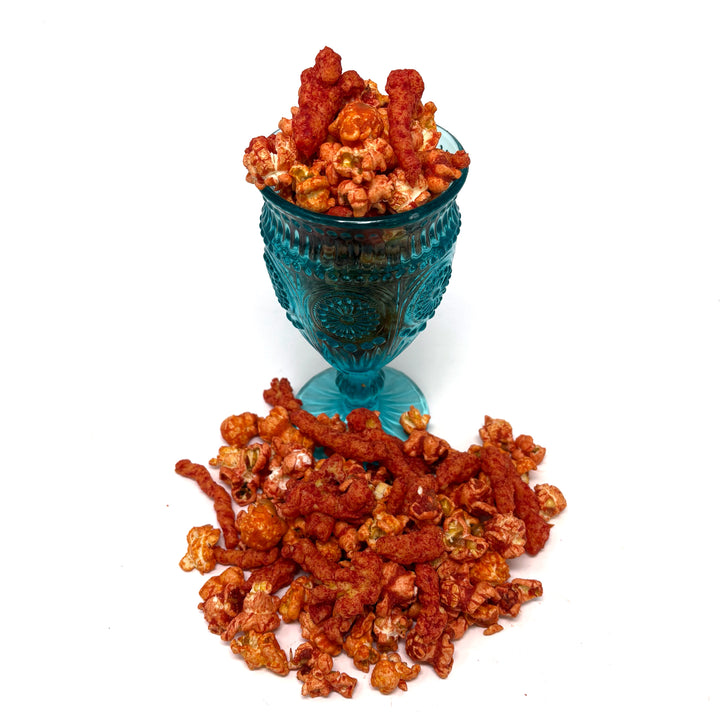  Our Eat My Dust Popcorn is a crave-worthy mix of White Cheddar and Better Cheddar popcorn that is coated in a light layer of fiery Hot Cheetos dust for a bold, cheesy heat that hits just right. Topped off with Hot Cheeto Dust and whole Hot Cheetos sprinkled throughout.