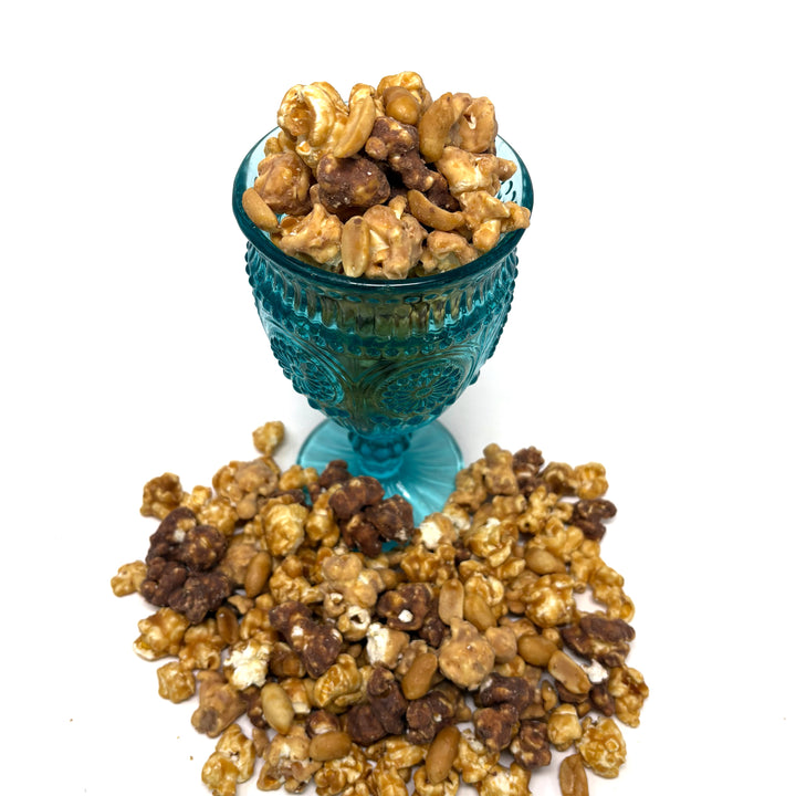 Your Favorite Candy Bar Popcorn includes a decadent chocolate-nougat blend that is combined with milk-chocolate-dipped salted vanilla caramel popcorn. Finished off with peanuts coated in our buttery caramel. 