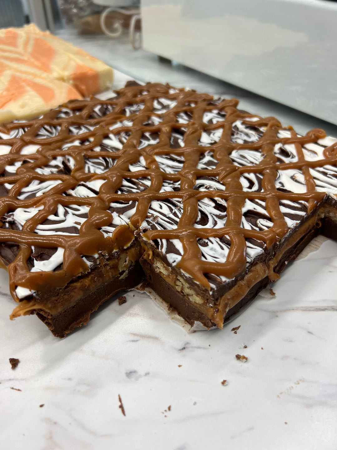 TorTush (Turtle) Fudge - Chocolate fudge with a gooey caramel nut center and white chocolate/ caramel topping