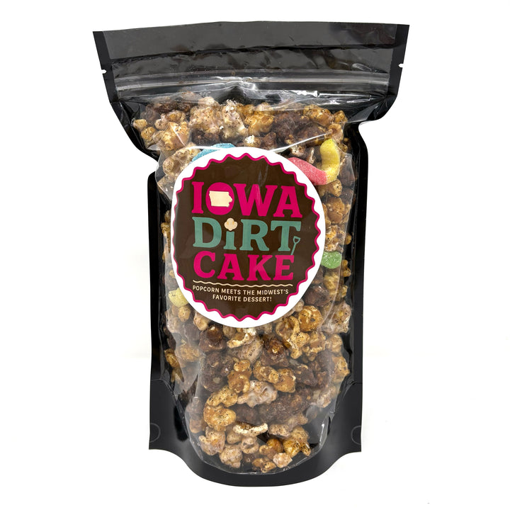 Our Iowa Dirt Cake Popcorn that includes our cream cheese popcorn, chocolate caramel popcorn, and our buttery caramel popcorn. We sprinkle it all in oreo dust and include a few gummy worms!