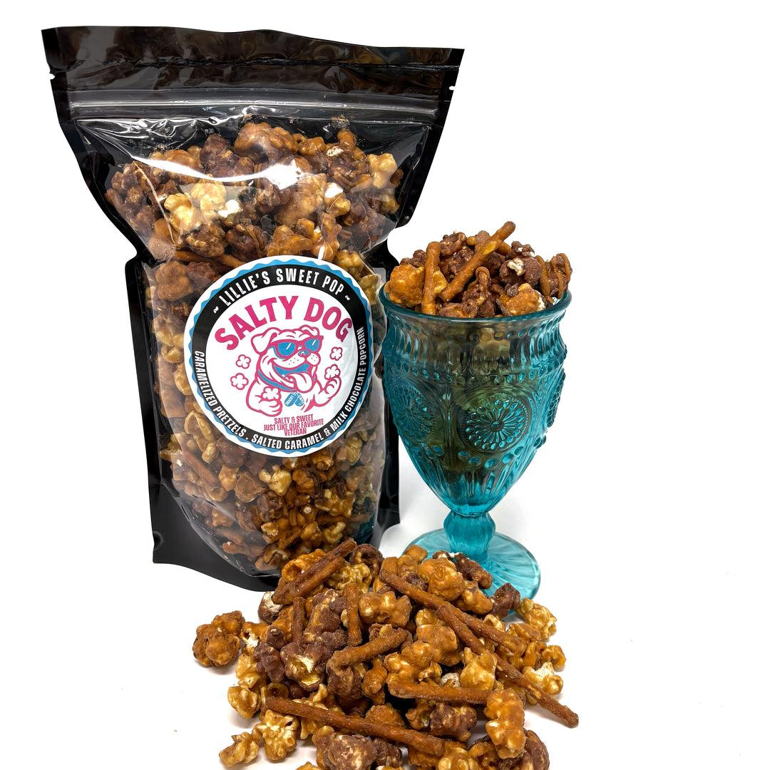 Salty Dog has salted vanilla caramel popcorn immersed in milk chocolate paired with our classic salted vanilla caramel popcorn. Finished off with a drizzle of sea salt chocolate and caramel-coated pretzels.