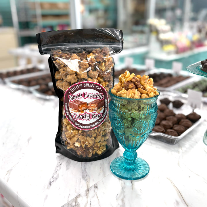 Your Favorite Candy Bar Popcorn includes a decadent chocolate-nougat blend that is combined with milk-chocolate-dipped salted vanilla caramel popcorn. Finished off with peanuts coated in our buttery caramel. 