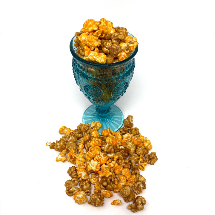 A close up of our Mae's Mix Popcorn that has our cheesy Better Cheddar mixed with buttery caramel popcorn. 
