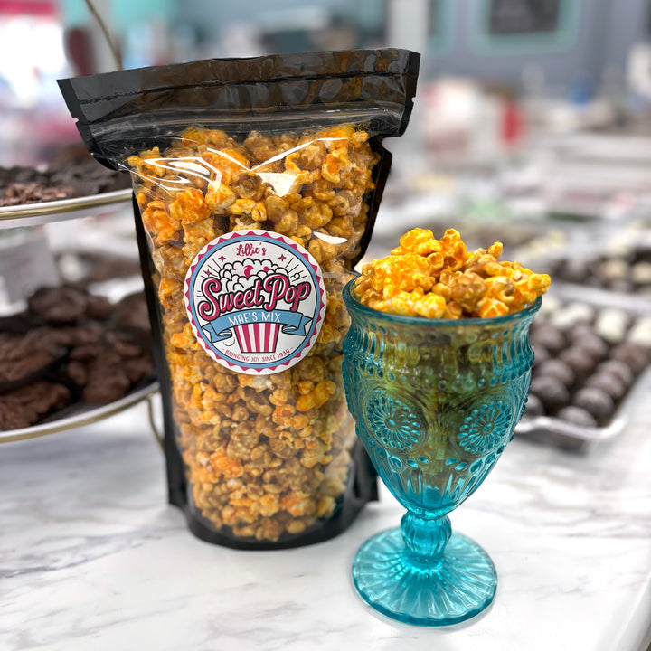 Mae's Mix Popcorn has a delicious blend of our buttery caramel popcorn and cheesy Better Cheddar popcorn. 