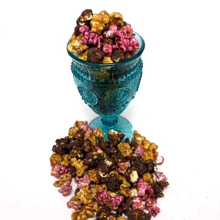 Our Raspberry Truffle Popcorn has a decadent blend of our buttery caramel popcorn, rich raspberry dark chocolate popcorn, and flavorful raspberry popcorn. 