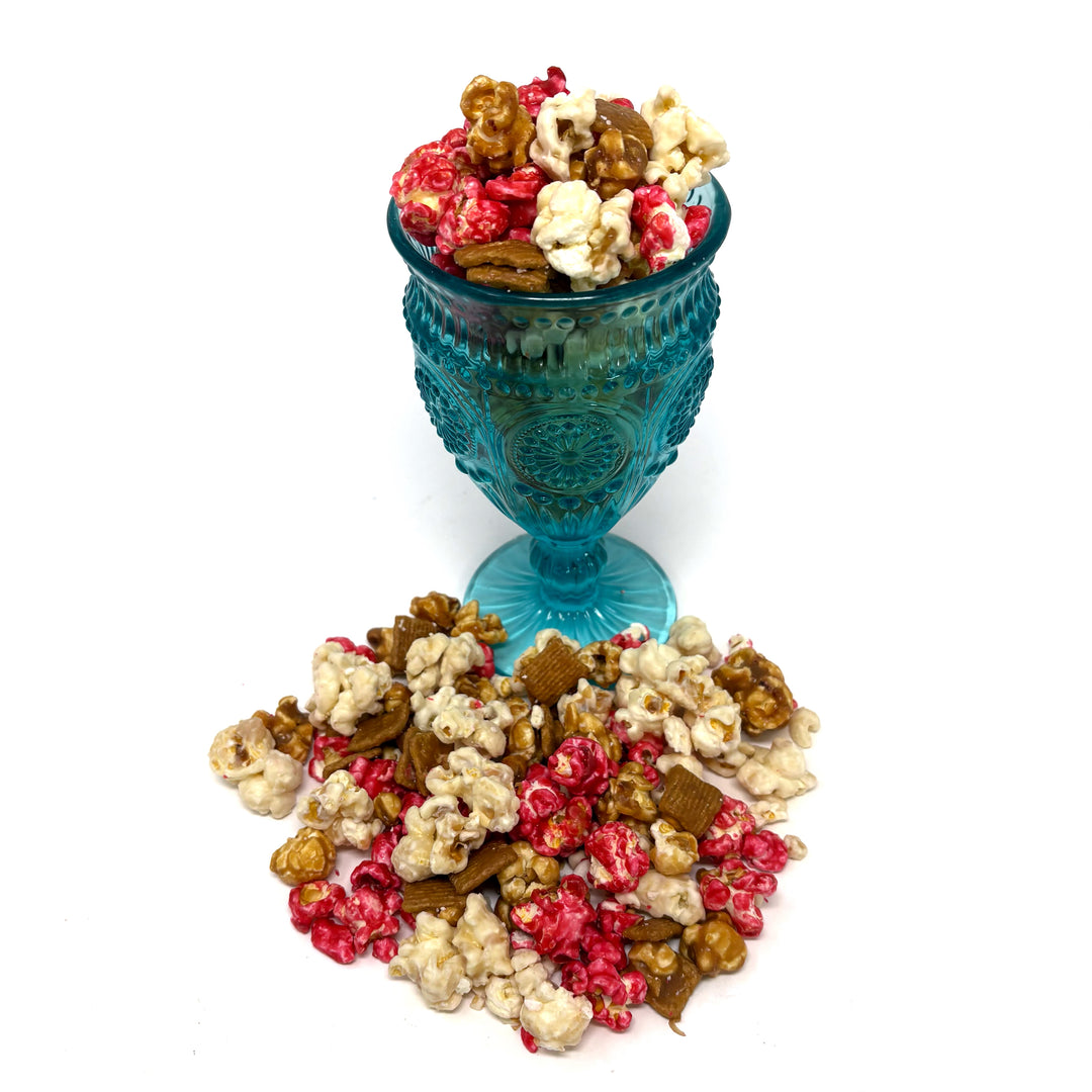 Our Strawberry Cheesecake popcorn has fruity strawberry popcorn, rich cheesecake white chocolate popcorn, and buttery caramel popcorn. Topped off with graham crackers for the perfect touch!