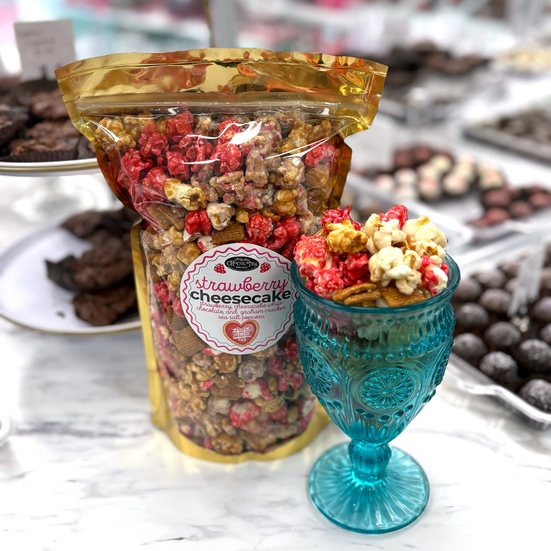 Our Strawberry Cheesecake popcorn has fruity strawberry popcorn, rich cheesecake white chocolate popcorn, and buttery caramel popcorn. Topped off with graham crackers for the perfect touch!
