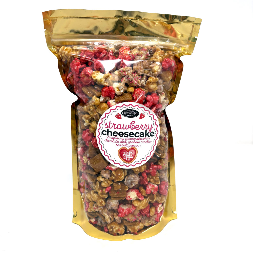 Our Strawberry Cheesecake popcorn has fruity strawberry popcorn, rich cheesecake white chocolate popcorn, and buttery caramel popcorn. Topped off with graham crackers for the perfect touch!