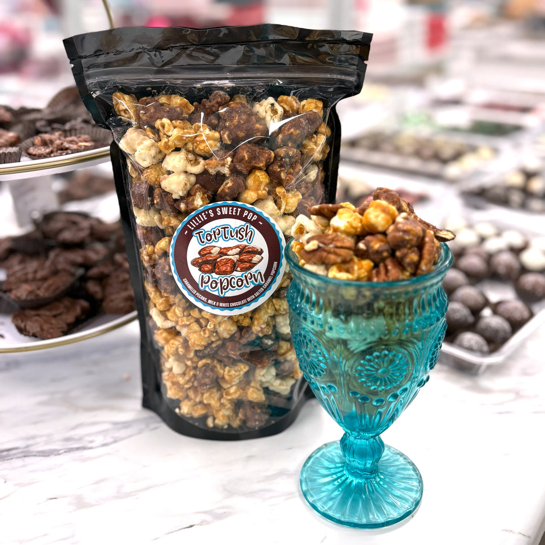 Our Tortush Popcorn has the flavors you know and love with our classic, buttery salted caramel popcorn and a blend of milk and white chocolate popcorn. Topped with caramelized pecans sprinkled throughout.