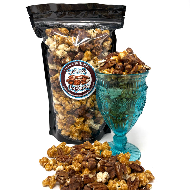 Our Tortush Popcorn has the flavors you know and love with our classic, buttery salted caramel popcorn and a blend of milk and white chocolate popcorn. Topped with caramelized pecans sprinkled throughout.
