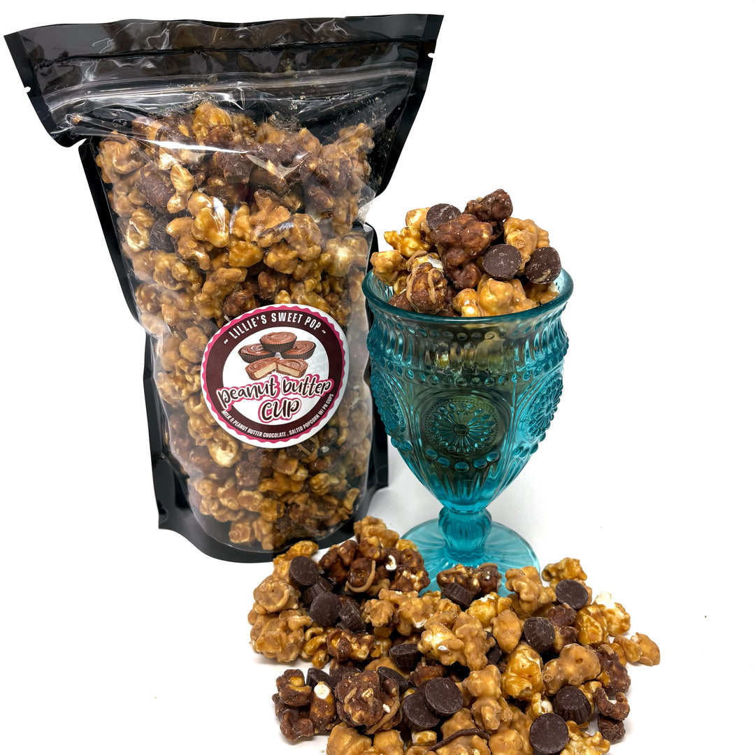 Our Ultimate Peanut Butter Cup Popcorn with our creamy and indulgent peanut butter caramel popcorn and chocolate caramel popcorn. Drizzled with peanut butter and topped with mini peanut butter cups.