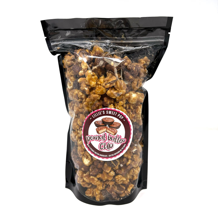 Our Ultimate Peanut Butter Cup Popcorn with our creamy peanut butter caramel popcorn and indulgent chocolate caramel popcorn. Finished off with mini peanut butter cups sprinkled throughout.
