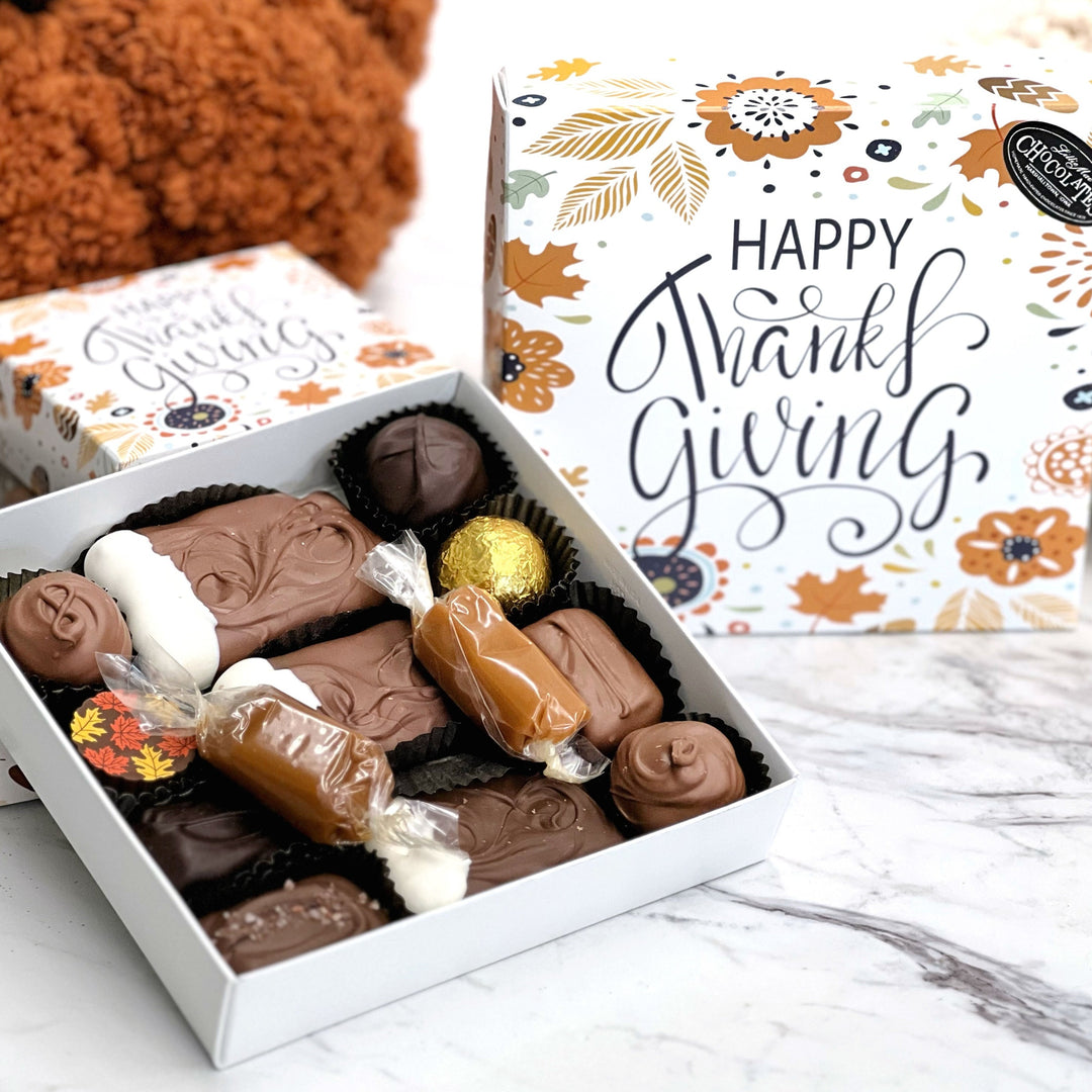 The deluxe assortment box says Happy Thanksgiving  box with all of your favorites in this cute fall gift box including soft center creams, truffles, sea salt caramels, chocolate covered caramels and wrapped caramel!